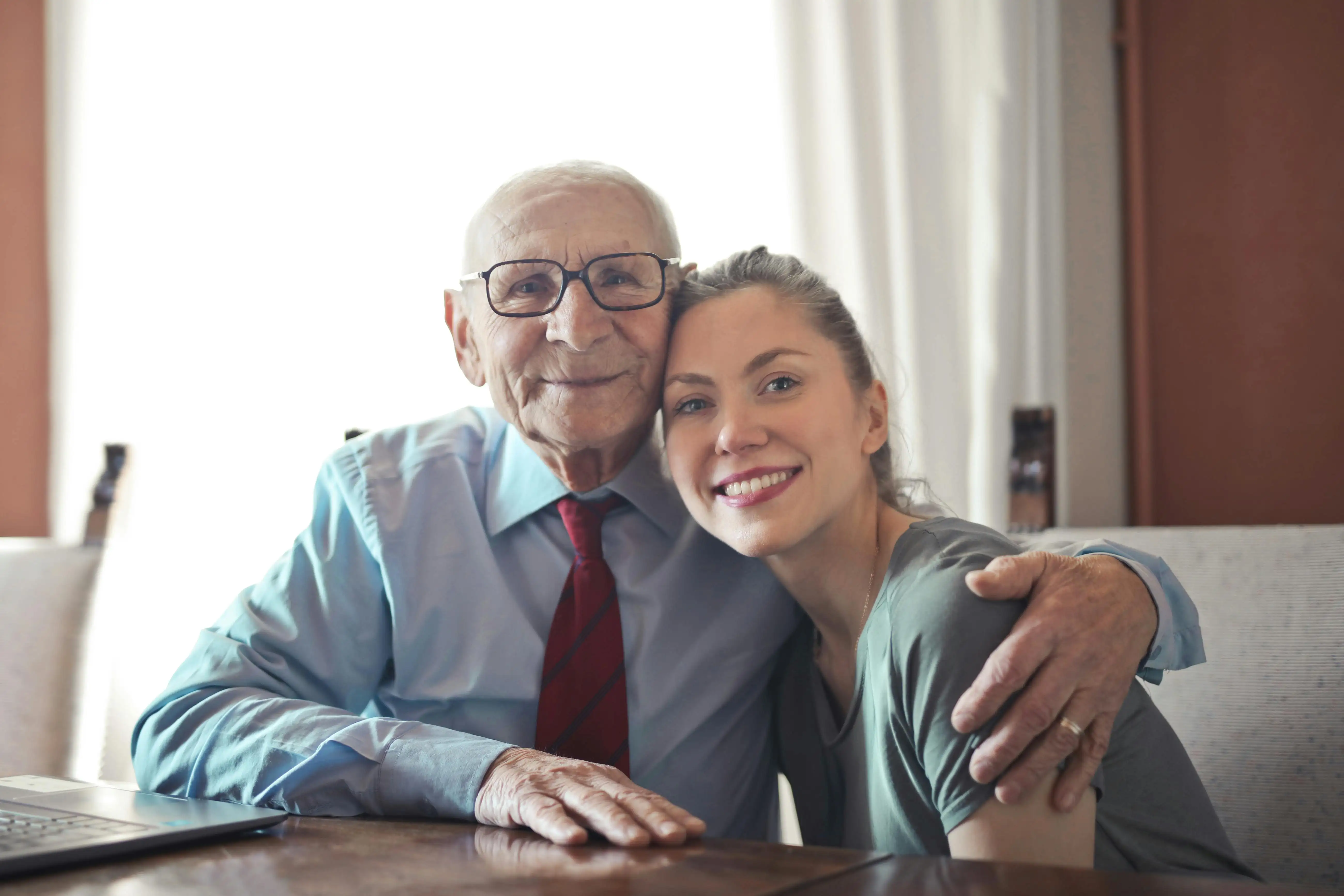 care provider posing for picture with senior patient