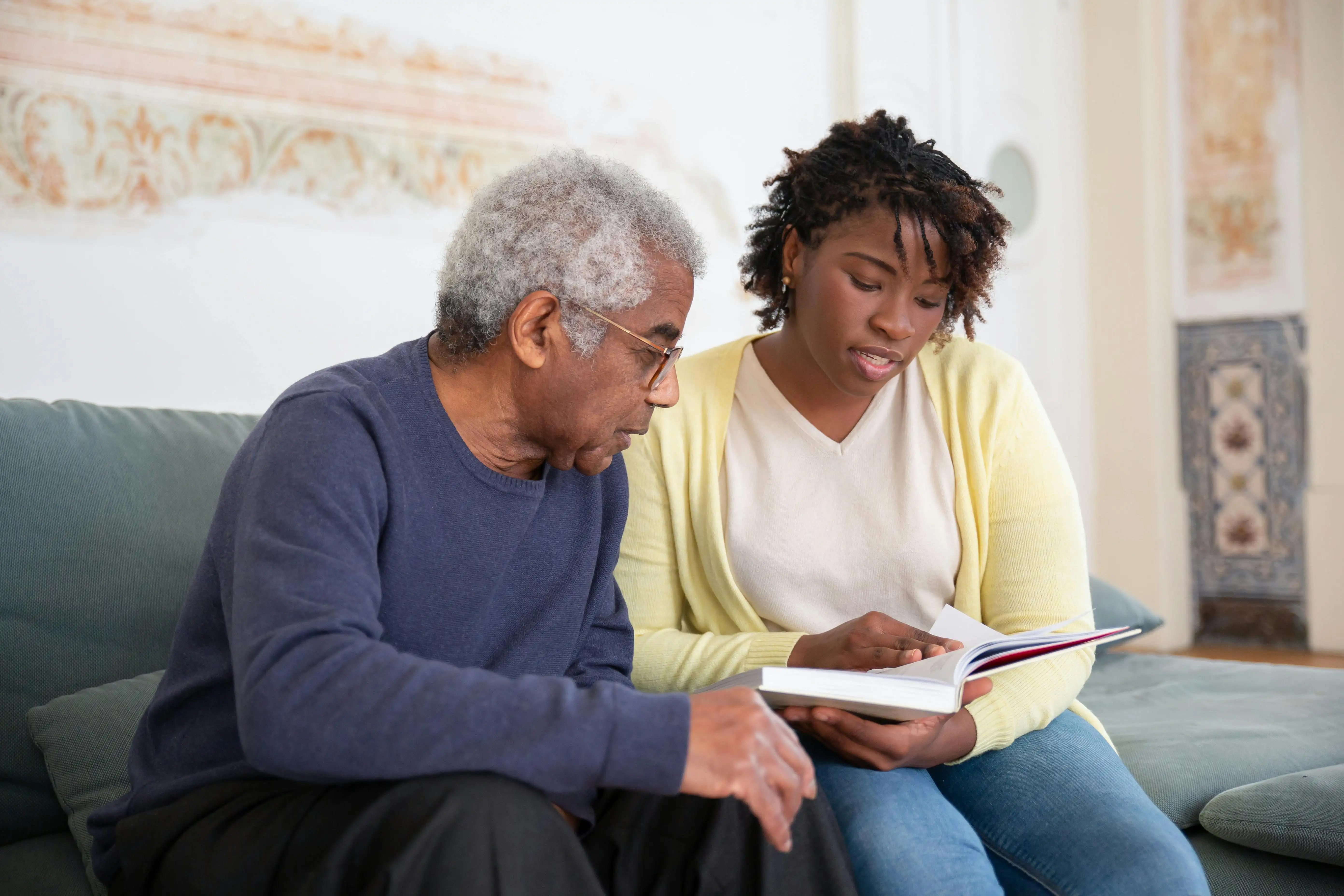 care provider reading with senior patient