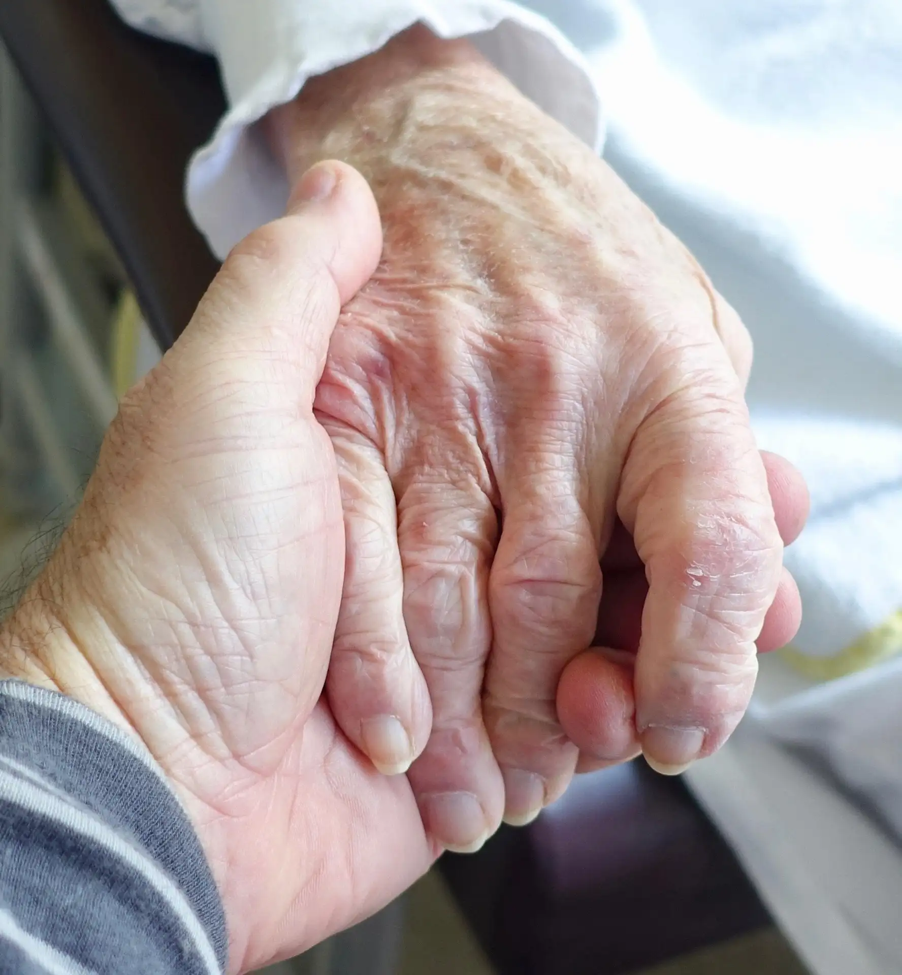 holding hands with senior patient