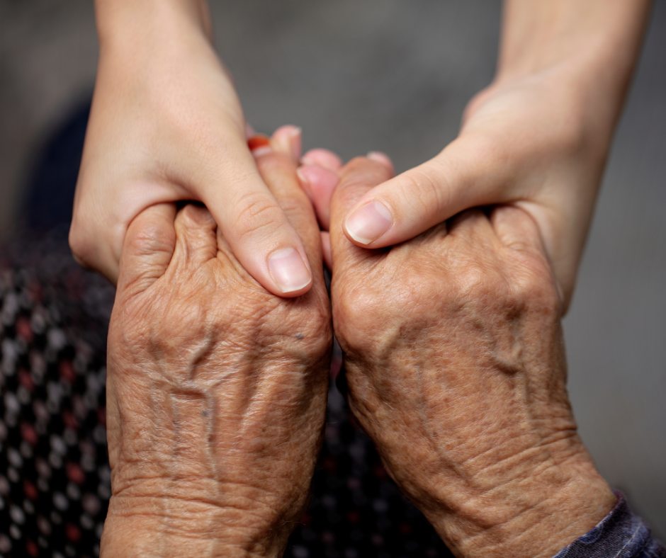 Mother caring for aging parent while child looks on at home
